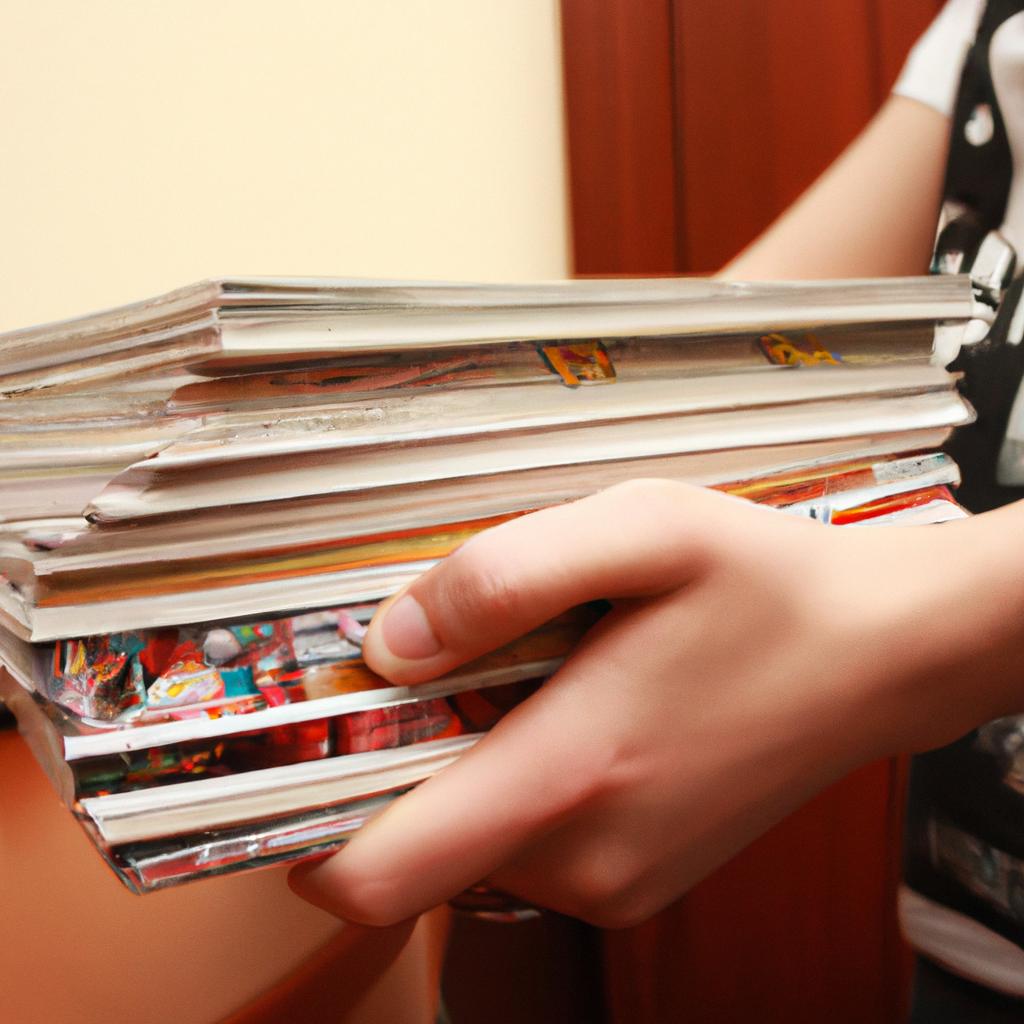 Person holding stack of comics